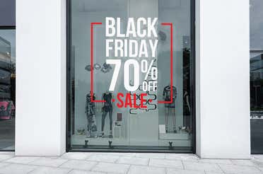 Vinyl lettering on a storefront window advertising a Black Friday sale.