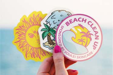 Stickers promoting beach cleanup event.