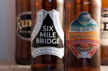 Beer bottles, each with a different branded label.