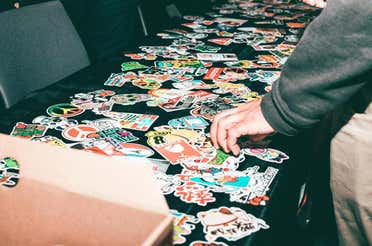 Many different stickers placed on a table.