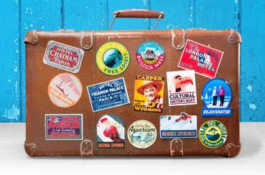 Paper stickers placed on a hand suitcase.