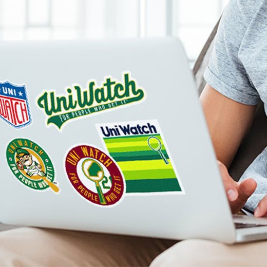Uni Watch stickers on a laptop