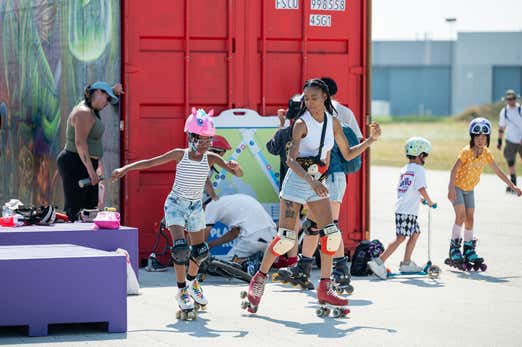 A woman gracefully rollerblading on a smooth path, wearing protective gear and enjoying the outdoors.