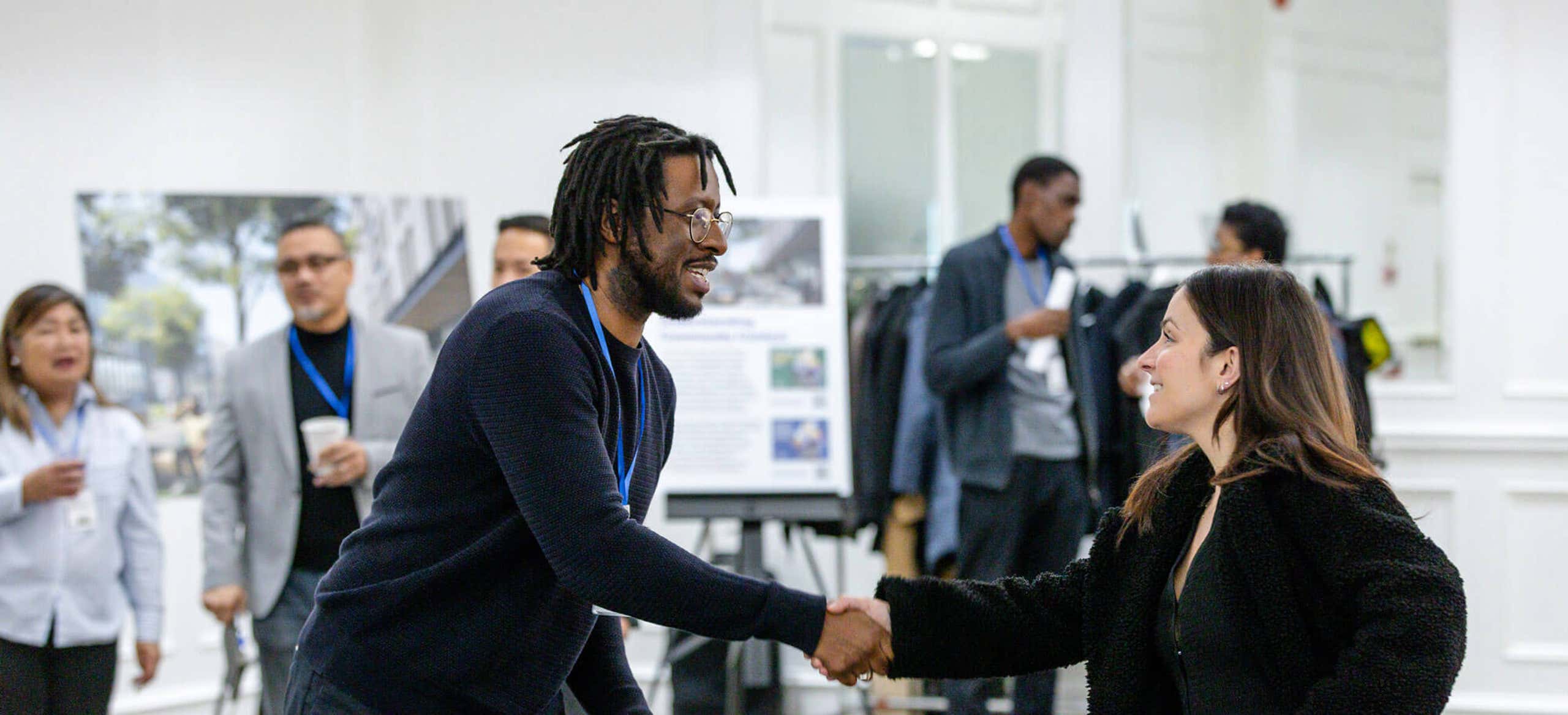 Photo of two people shaking hands at a networking event
