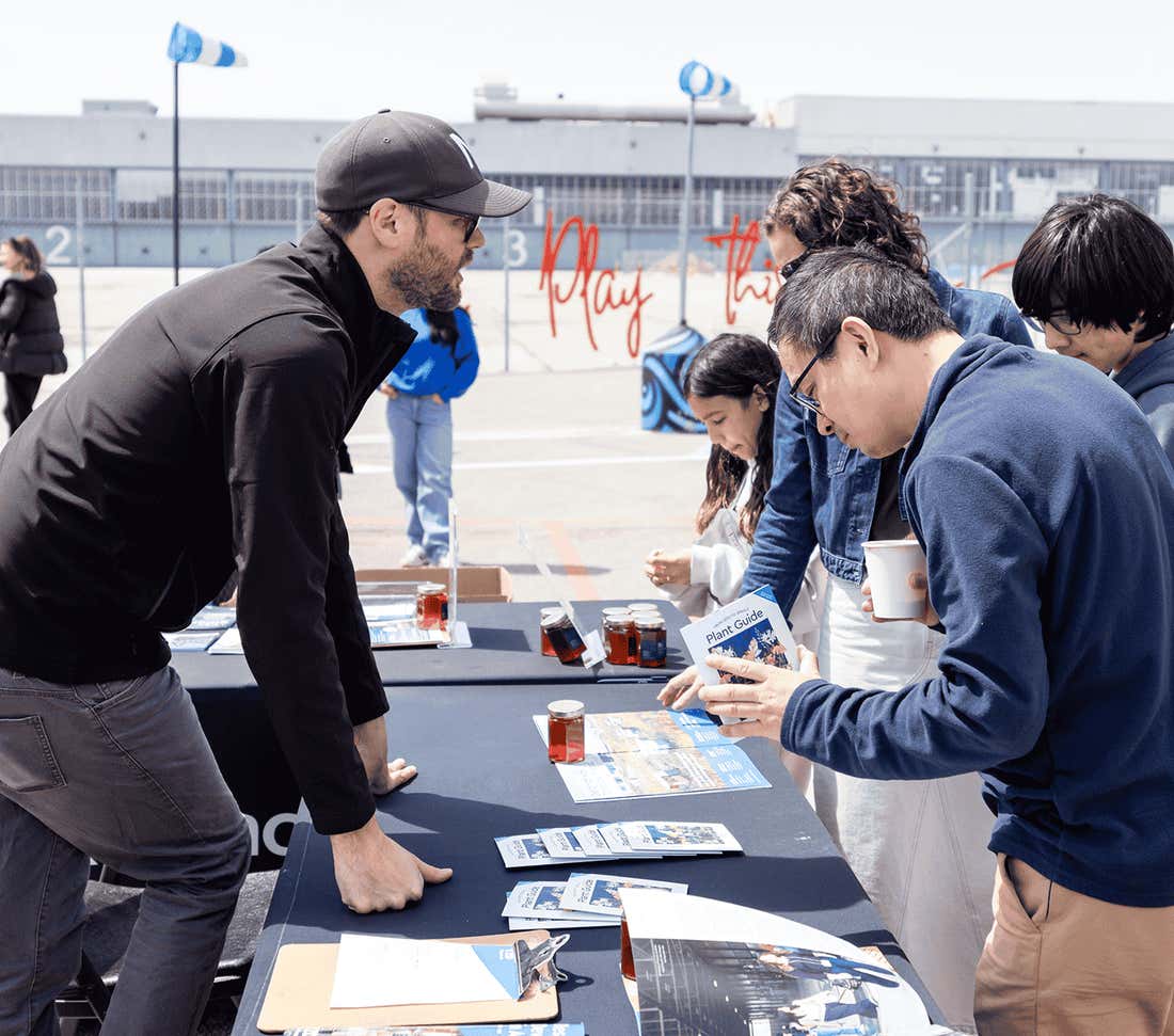 People at an information table speaking to an attendee